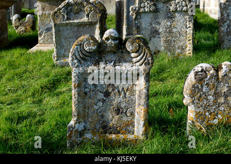 Old gravestones in St. Mary`s churchyard, Swinbrook, Oxfordshire, England, UK Stock Photo